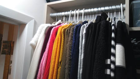 Color coded sweaters in rainbow pattern